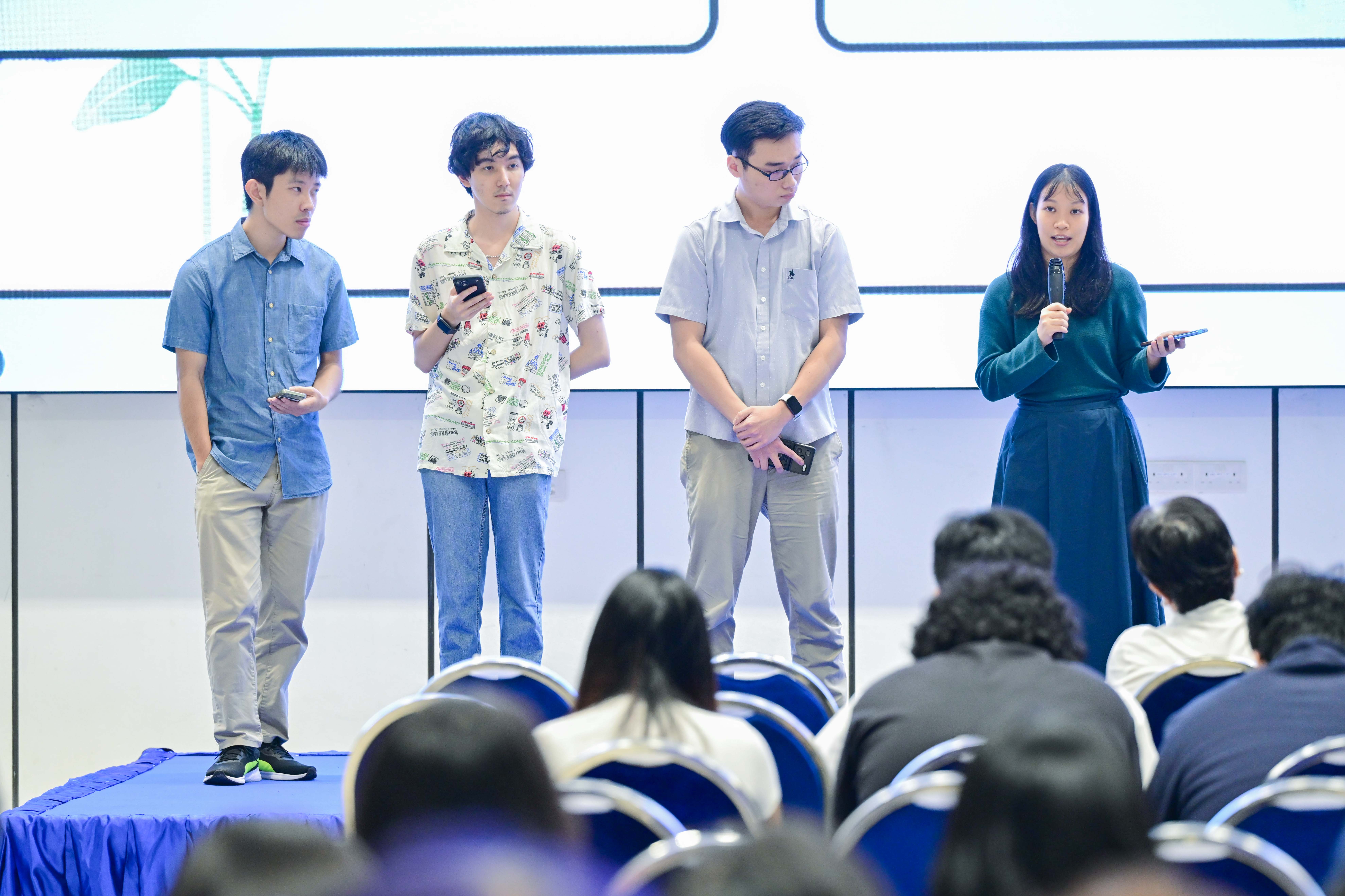Four students explaining their problem statement to the audience